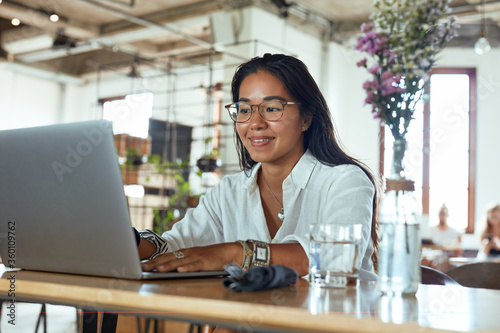Work. Business Woman In Cafe Portrait. Smiling Freelancer Looking At Screen And Typing. Fashion Girl In Glasses Working On Laptop And Waiting For Lunch In Restaurant.