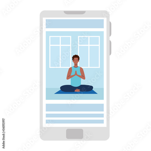 online, yoga concept, man afro practices yoga and meditation, watching a broadcast on a smartphone
