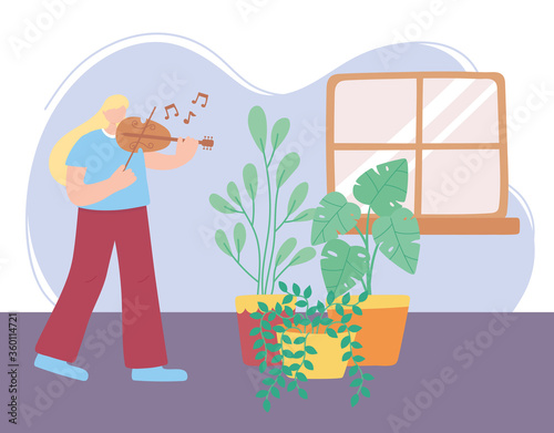 stay at home, girl playing fiddle in room with plants, self isolation, activities in quarantine for coronavirus