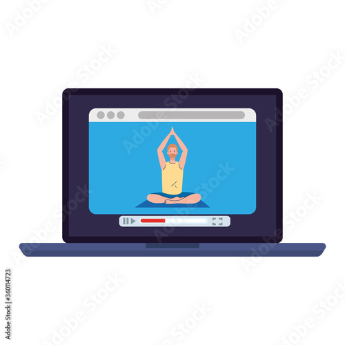 online, yoga concept, man practices yoga and meditation, watching a broadcast on a laptop computer