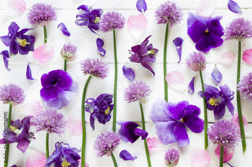 Flowers flat design, purple  and pink  flowers on white wooden board,  floral pattern  in flat lay style .Template for greeting card