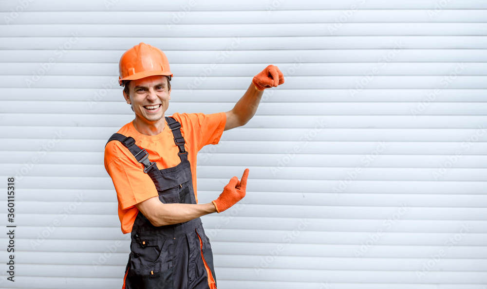 Young happy laughing man builder construction worker with hands in different position looking at the camera on white background Young happy laughing man builder construction worker with hands in different position looking at the camera on white background