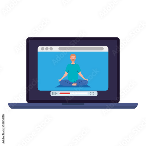 online, yoga concept, man practices yoga and meditation, watching a broadcast on a laptop computer