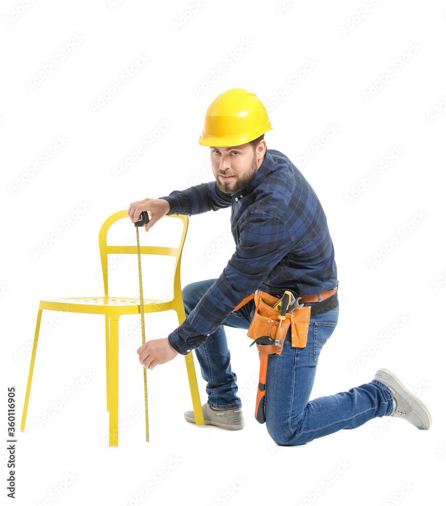 Male carpenter using tape measure on white background Male carpenter using tape measure on white background