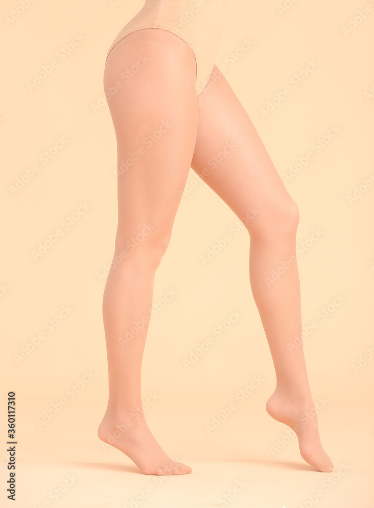 Beautiful young woman in tights on color background Beautiful young woman in tights on color background