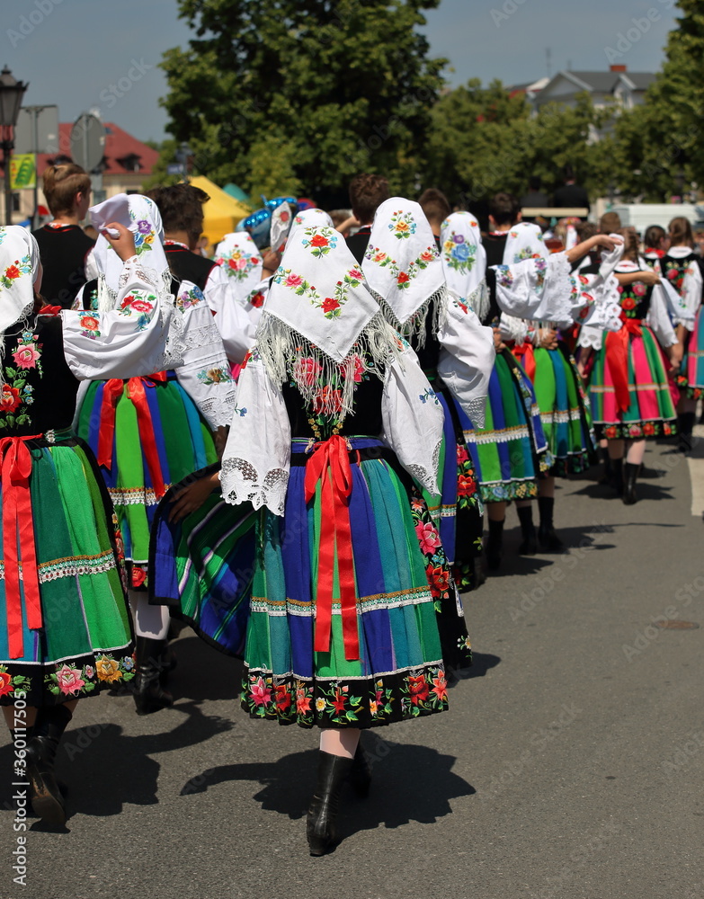 Local people in traditional folk costume from Lowicz region in Poland while walk in Corpus Christi procession