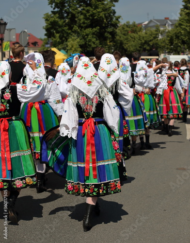 Local people in traditional folk costume from Lowicz region in Poland while walk in Corpus Christi procession