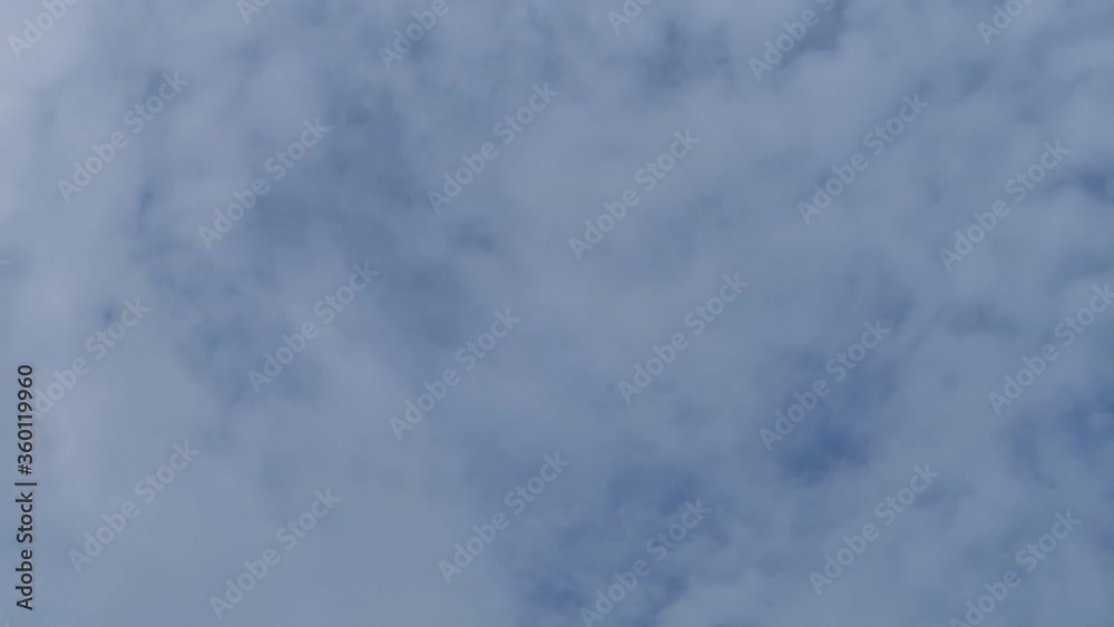 TimeLape of dramatic fast moving white cumulus & cirrocumulus clouds or puffy fluffy cloudscape on beautiful sunny blue sky background in tropical summer or spring sunlight & sun rays at sunshine day TimeLape of dramatic fast moving white cumulus & cirrocumulus clouds or puffy fluffy cloudscape on beautiful sunny blue sky background in tropical summer or spring sunlight & sun rays at sunshine day