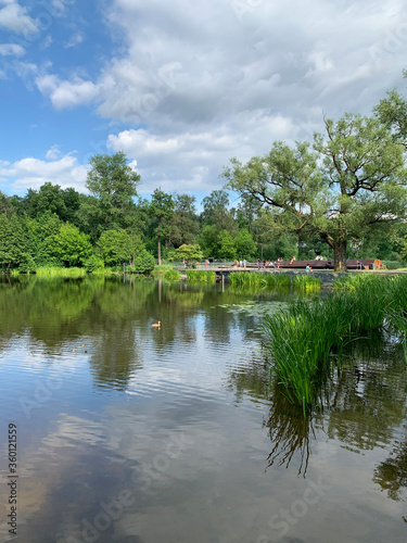 Pekhorka river in cloudy weather in June and the embankment in Pekhorka Park. Moscow region  city of Balashikha  Russia