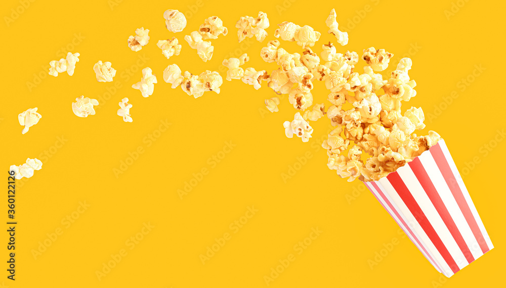 popcorn in classic red and white bucket splashing out of the box in yellow background