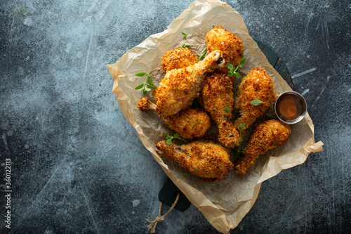 Panko breaded fried chicken drumsticks with hot honey sauce photo