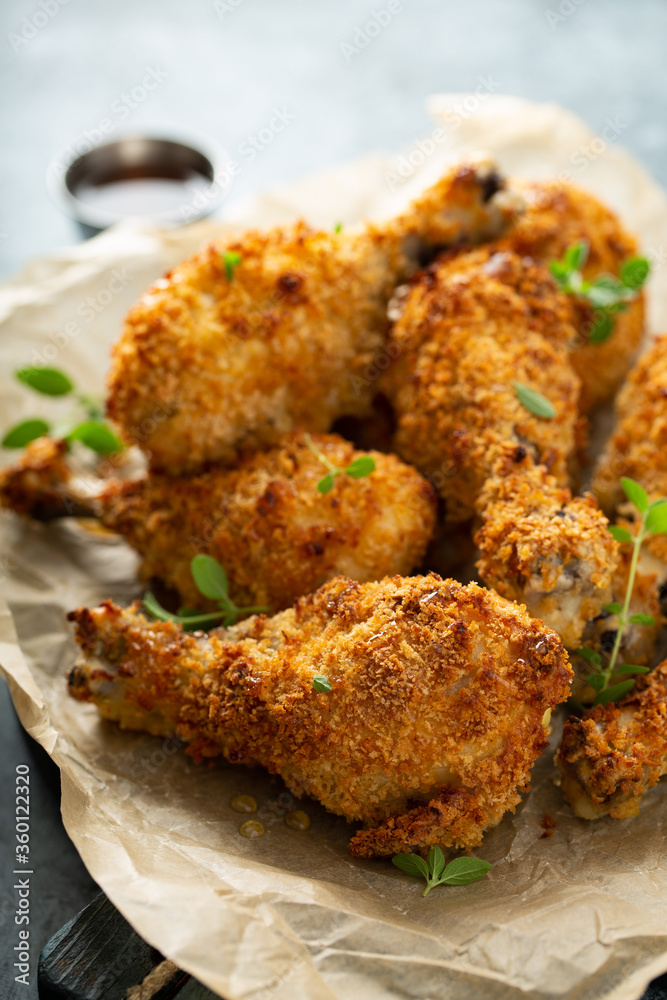 Panko breaded fried chicken drumsticks with hot honey sauce Stock Photo