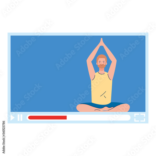 online, yoga concept, man practices yoga and meditation, watching a broadcast on a web page