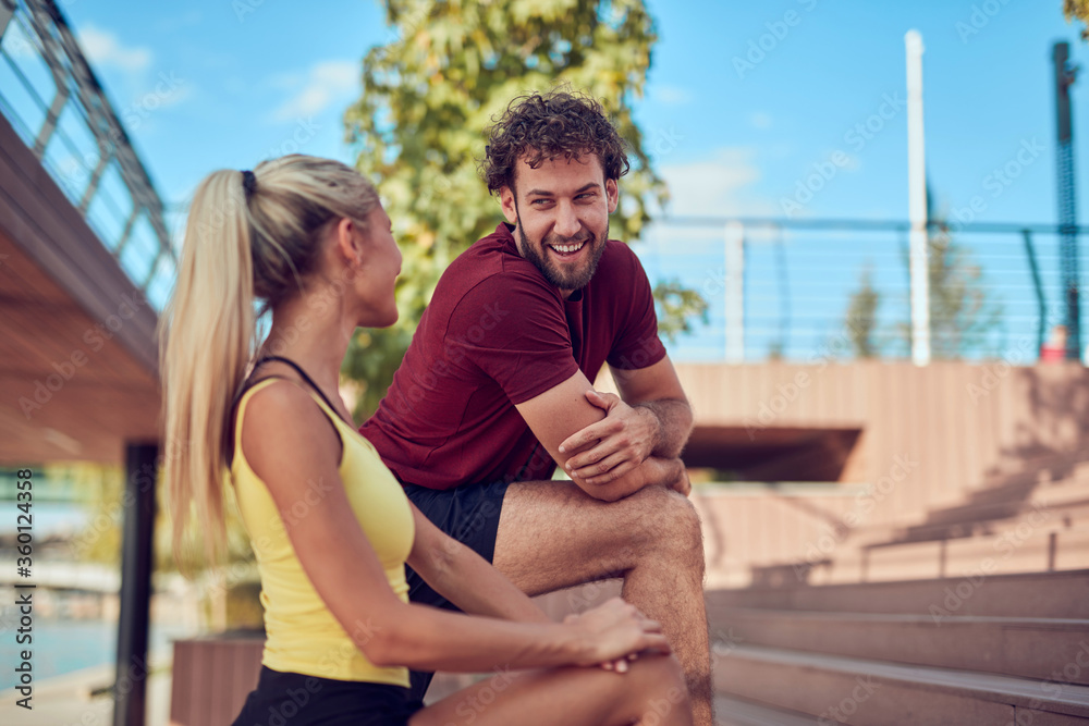 Modern couple doing exercise in urban area.