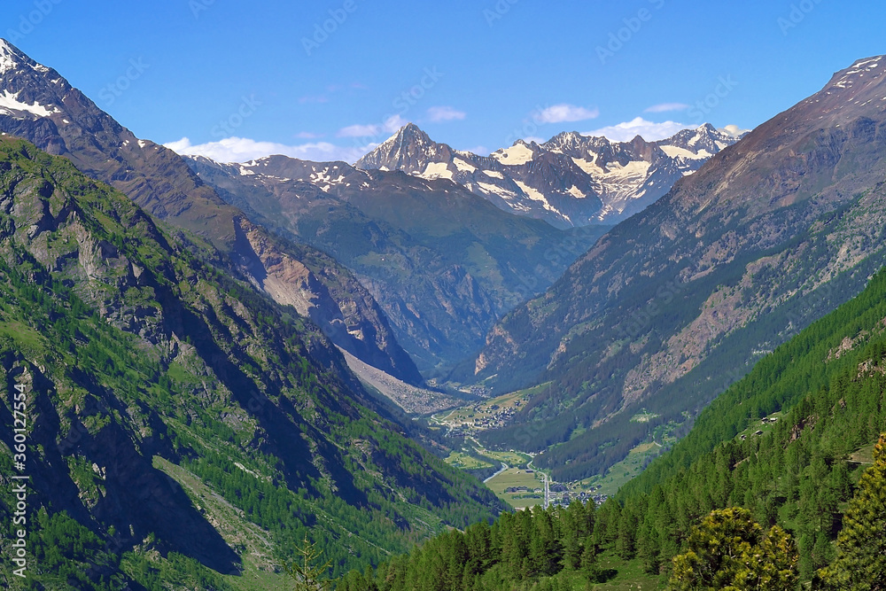 summer time Switzerland Zermatt city surround by green tree forest with snow mountain on background panoramic aerial view from upper in wide angle