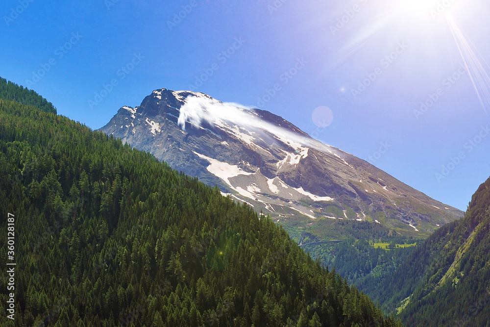snow mountain peak covoring by cloud on sunny dark blue sky background on summer at Switzerland