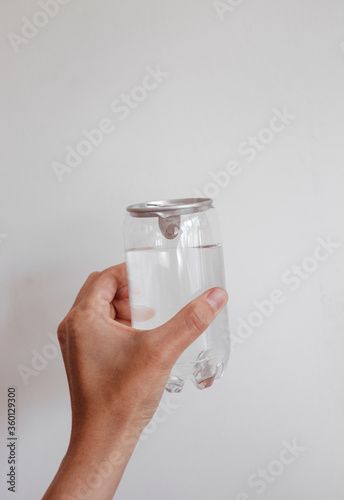 clean water in transparent can in hand