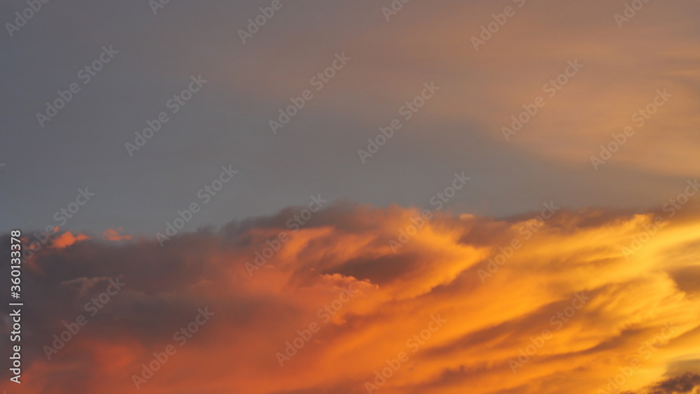 Fototapeta premium Gold color cloud and blue sky in magic hour at sunset, The horizon began to turn orange with purple and pink cloud at night, Dramatic cloudscape area
