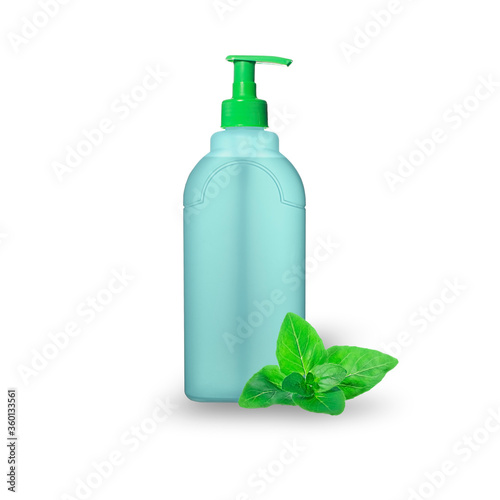 A blue transparent plastic bottle with a green pump and a green fresh marjoram leaves isolated on white background