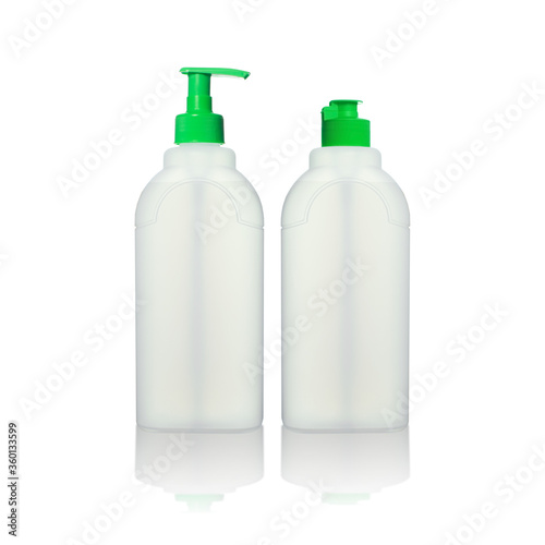 Two white plastic transparent bottles with green caps with reflection isolated on white