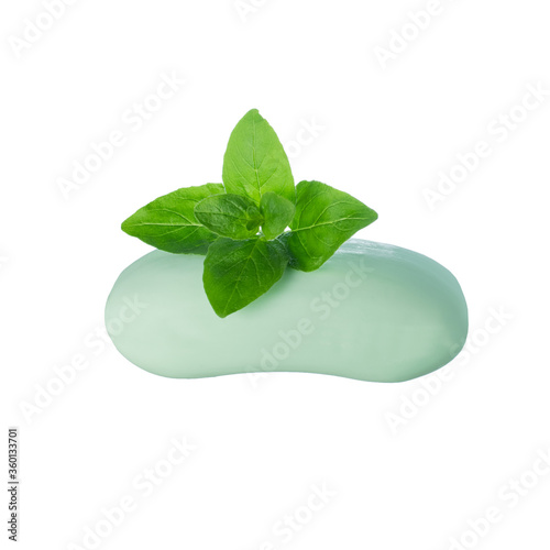 A mint color soap with marjoram leaves on top isolated on white 
