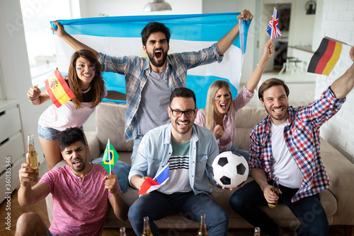 Group of multi-ethnic people celebrating football game © NDABCREATIVITY