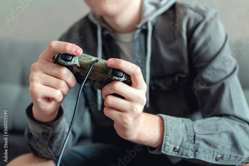 teenager playing a game console