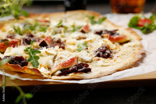 A flatbread with goat cheese, figs and red onion jam. Tasty pizza on crunchy dough.