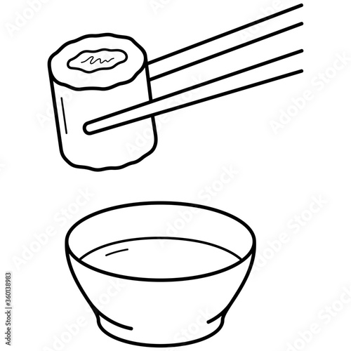 Sushi roll in chopsticks and bowl of sauce