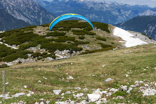 A paraglider at the start of the Krippenstein mountain in the Dachstein Mountains. Salzkammergut. Austria