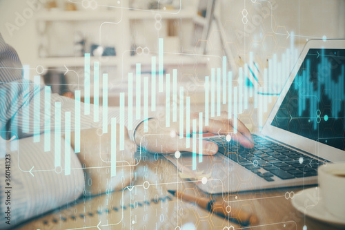 Multi exposure of stock market chart with man working on computer on background. Concept of financial analysis.