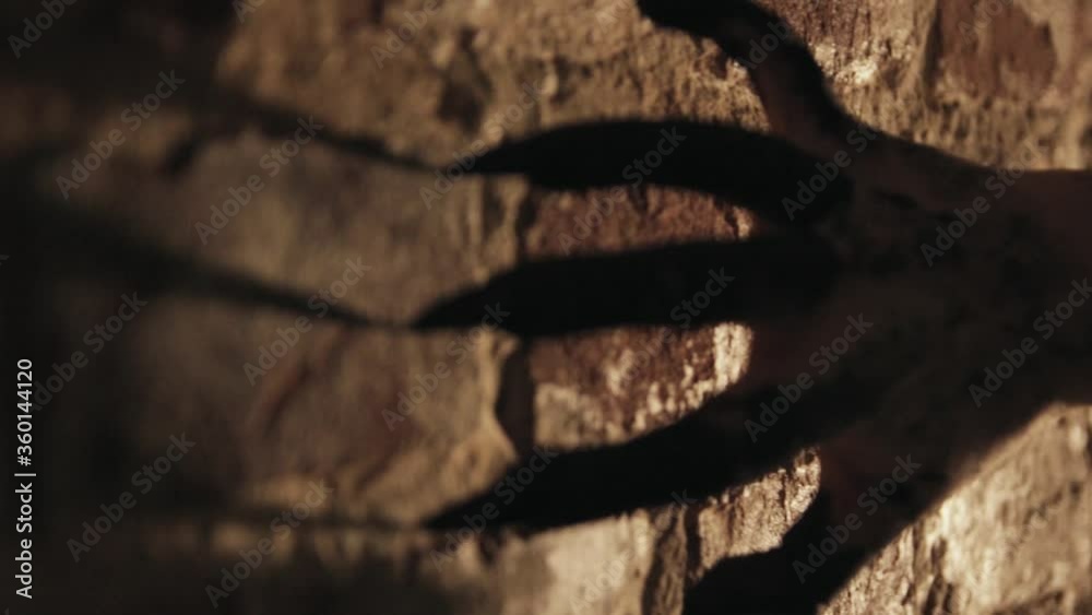 Black scary sharp claws of the devil scrape on a stone wall. Monster hand