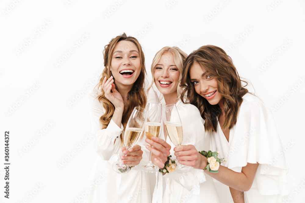 Photo of joyful beautiful bridesmaids laughing and drinking champagne Photo of joyful beautiful bridesmaids laughing and drinking champagne