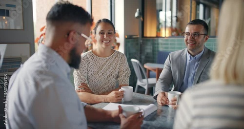 Smiling businesspeople
talking in a lounge

