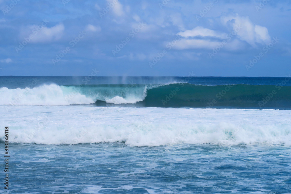 Blue closing surfing wave at popular surf beach Balangan in Bali island, Indonesia