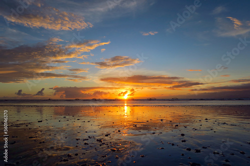 Quadro em tela Beautiful Kuta beach sunset with clouds, rocks on sand and reflection, Bali isla