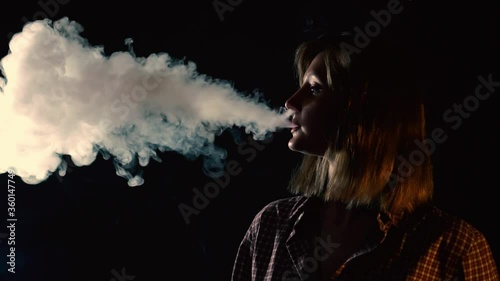 girl exhales steam from vape