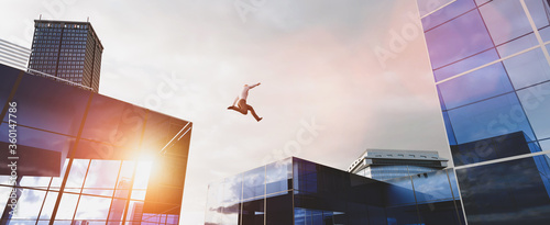 Man jumping between skyscrapers. Business success