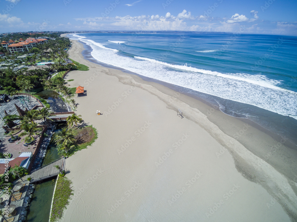 Absolutely empty Petitenget Beach (Pantai Petitenget) closed for quarantine  for COVID-19. Seminyak, one of Bali most popular tourist areas. Indonesia.  Aerial drone image. Photos | Adobe Stock