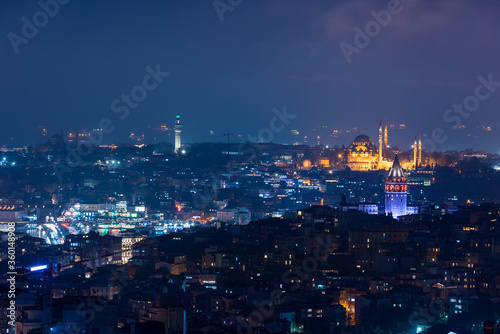 Galata Tower and Suleymaniye Mosque at night in Istanbul, Turkey.