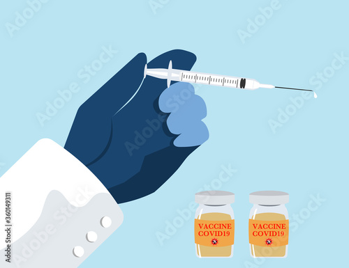 Hand bring syringe with vaccine bottle 