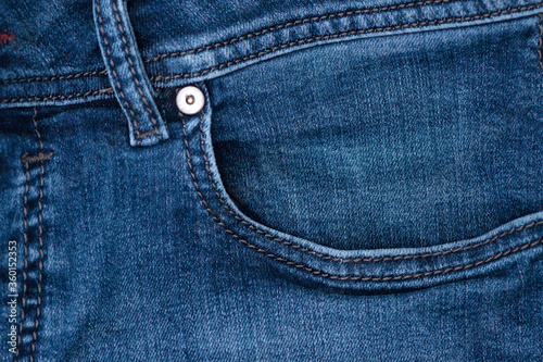 close view of a blue denim stone washed jean pocket © ThomasLENNE