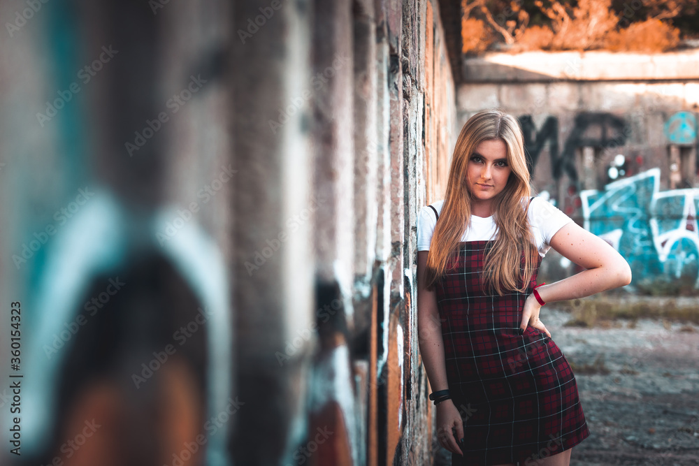 Fototapeta premium Young girl posing in old ruins.