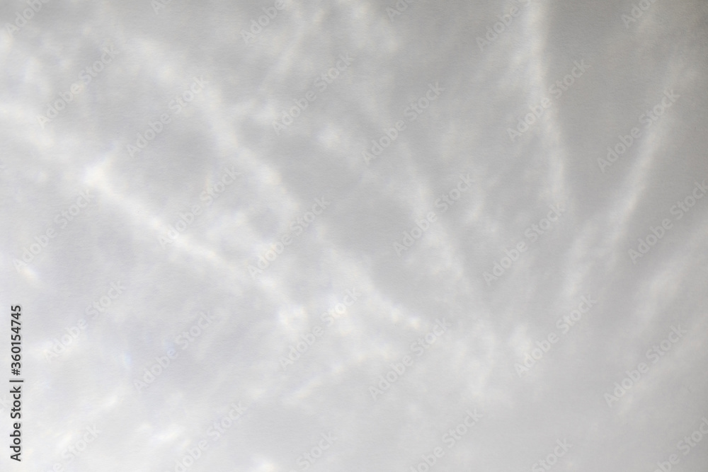 Obraz premium Water texture overlay effect for photo and mockups. Organic drop diagonal shadow and light caustic effect on a white wall. Shadows for natural light effects