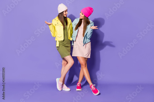 Full length body size view of nice fashionable attractive lovely cheerful cheery girls talking chill out spending time isolated over bright vivid shine vibrant violet lilac purple color background