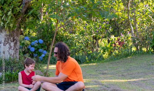 Uncle and nephew meditating and playing in nature.