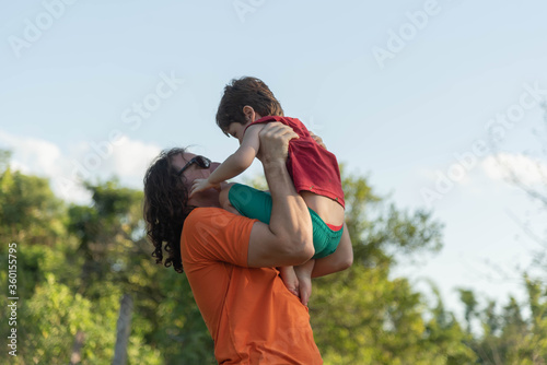 Uncle and nephew playing together in the middle of nature.