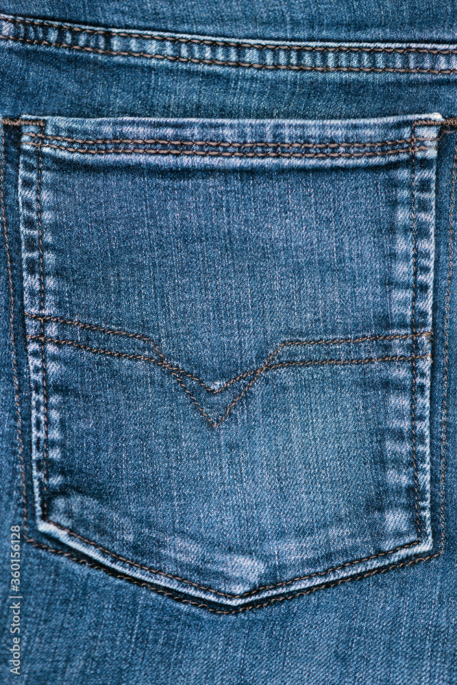 close view of blue denim stone washed rear jean pocket close view of blue denim stone washed rear jean pocket