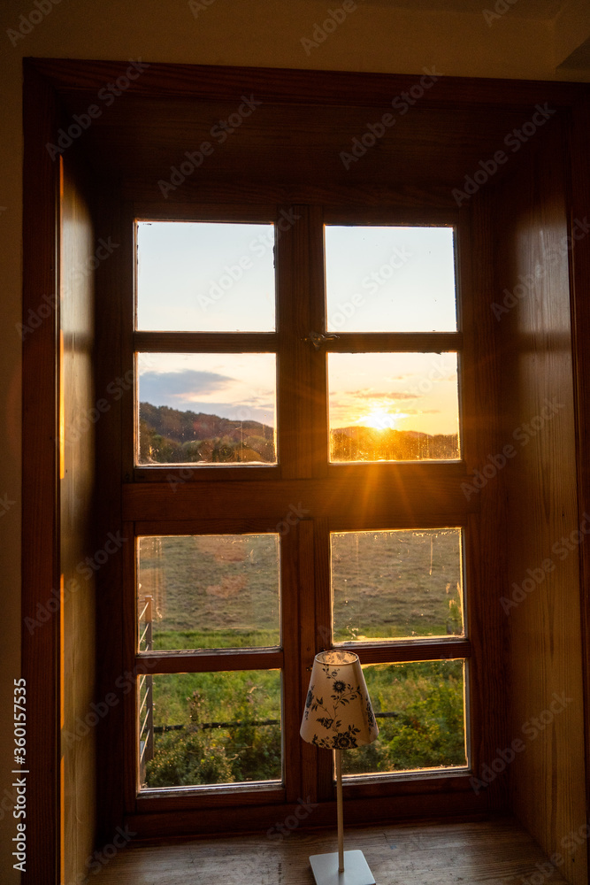 Sunset at lake house river through wooden window Sunset at lake house river through wooden window
