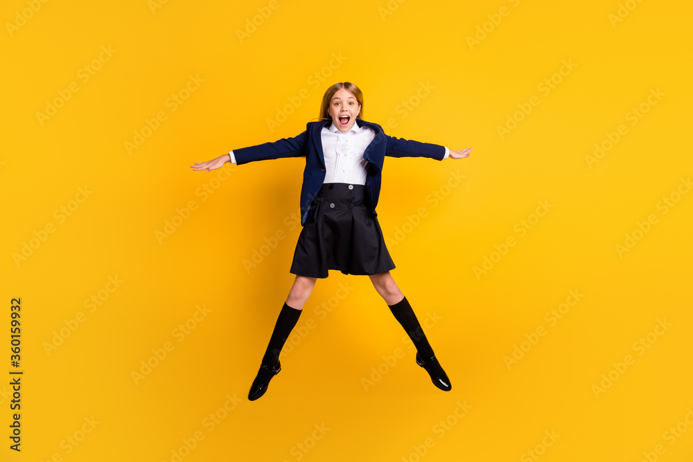 Full length body size view of her she attractive small little cheerful free careless overjoyed girl jumping having fun vacation holiday isolated bright vivid shine vibrant yellow color background
